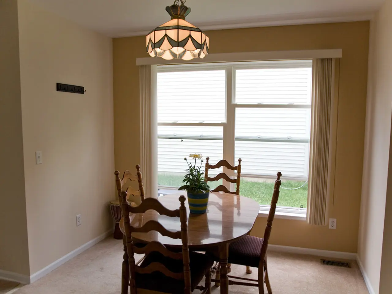 An indoor picture. We can able to see chairs and tables. On this table there is a plant. This is...