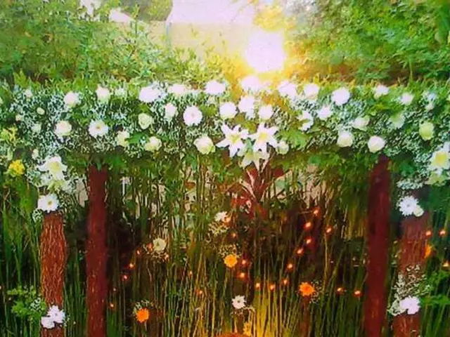 This picture is completely decorated with flowers and it is a greenery picture. Here we can see a...