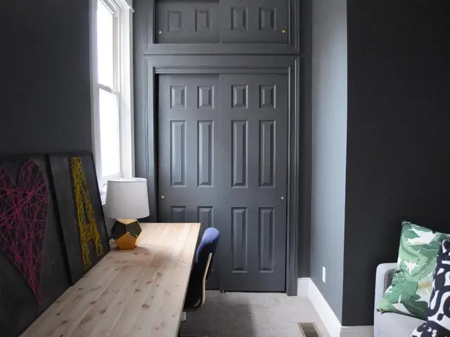 This picture is clicked inside the room. On the left side, we see a blue chair and a table on which...