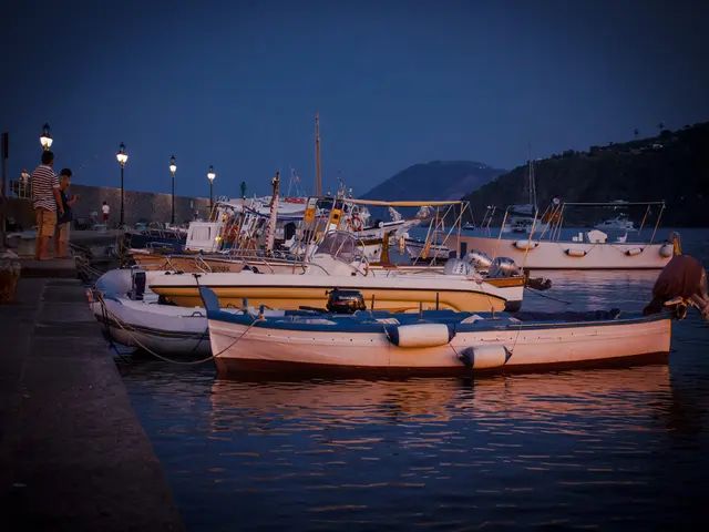 In the center of the image there are boats. At the bottom there is river. On the left there are...