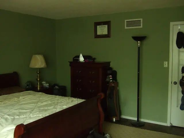 In the picture we can find a house, it is a bed room and we can find a bed, bed sheet, lamp,...