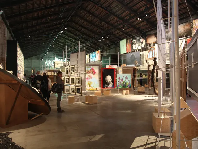 In the image we can see there is an art gallery where people are standing on the floor and there...